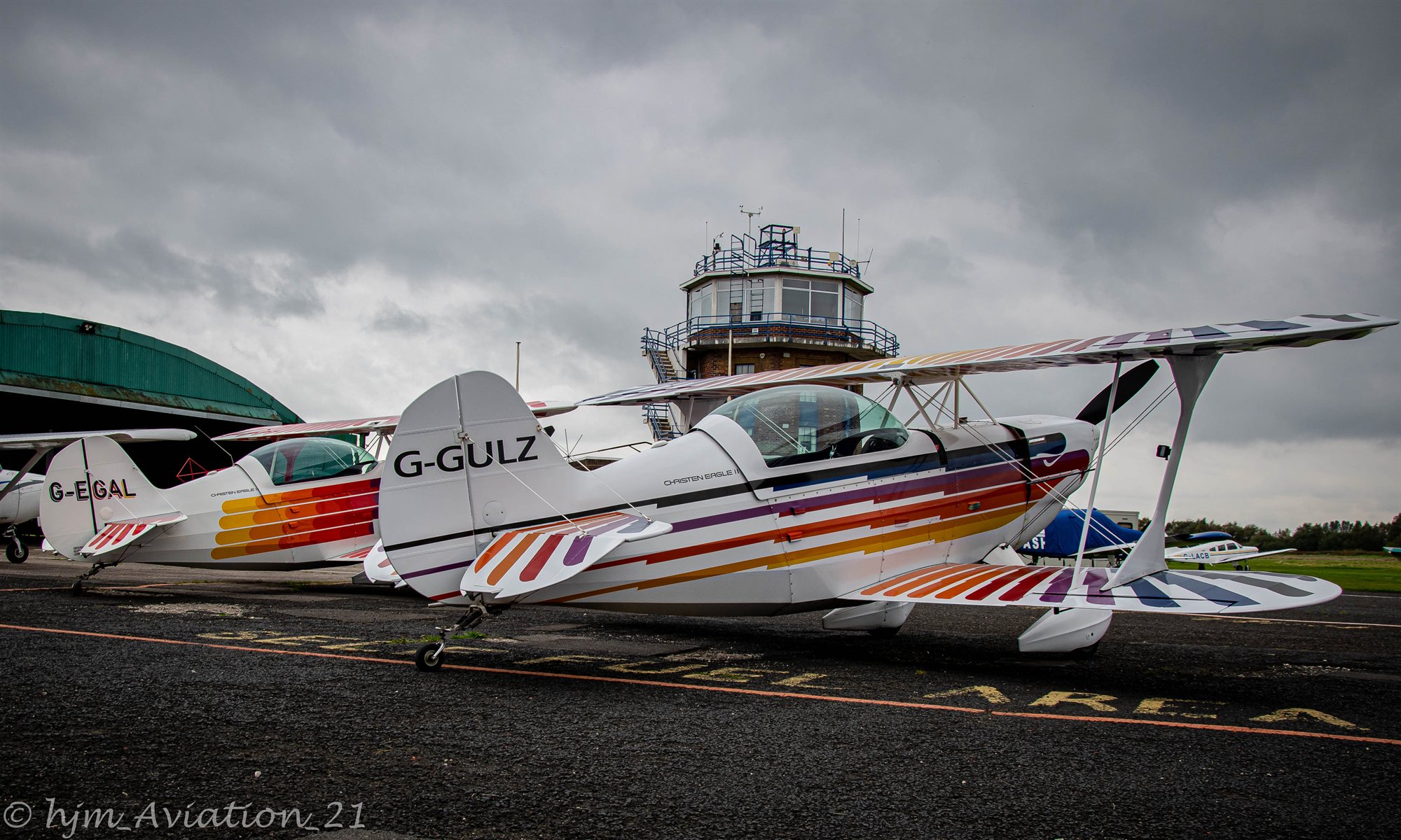 Colourful aerobatic biplane on the apron — photograph by Harry